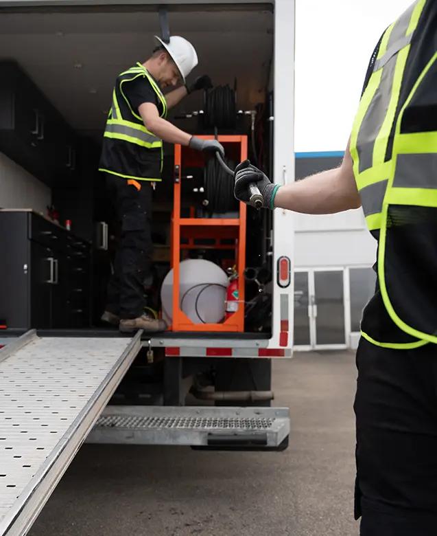 drain cleaning service truck operating in Leduc residential area