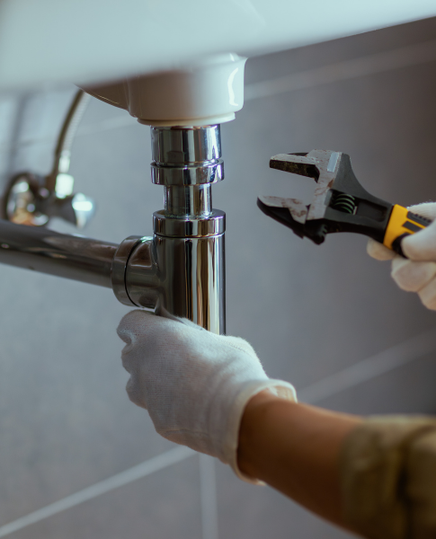 Technician cleaning bathroom drain